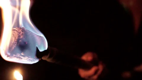 Lighting a Torch in the Dark in Slow Motion Stock Footage