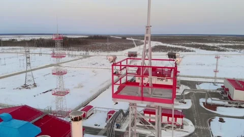 Lighting tower of an industrial facility, a drone flies over a metal tower. The Stock Footage 195229603
