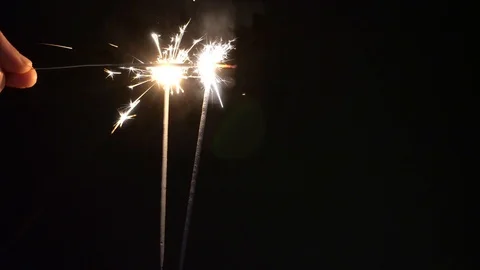 Lighting two Sparklers on black background Stock Footage 123522449