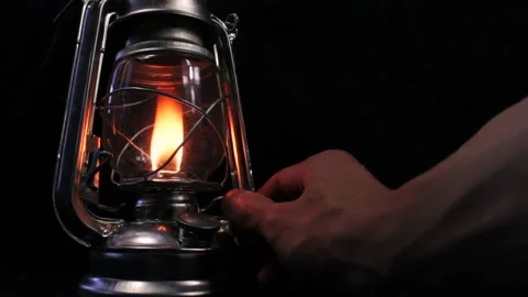 Lighting up a vintage lantern in the darkness Stock Footage 233482202