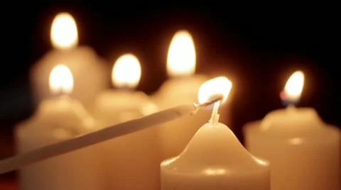 Lighting votive candle Stock Footage