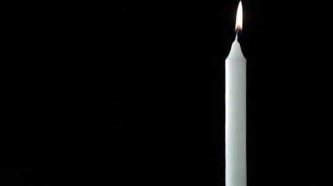 The lighting of a white candle on black background Stock Footage 54046497