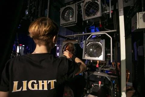 A lighting worker prepares the lamps before the performance begins Stock Photos