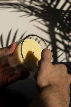 Lighting Yellow Candle Close Up with Flame Foto stock