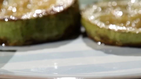Lightly browned squash is being  dished out, close up Stock Footage 113497206
