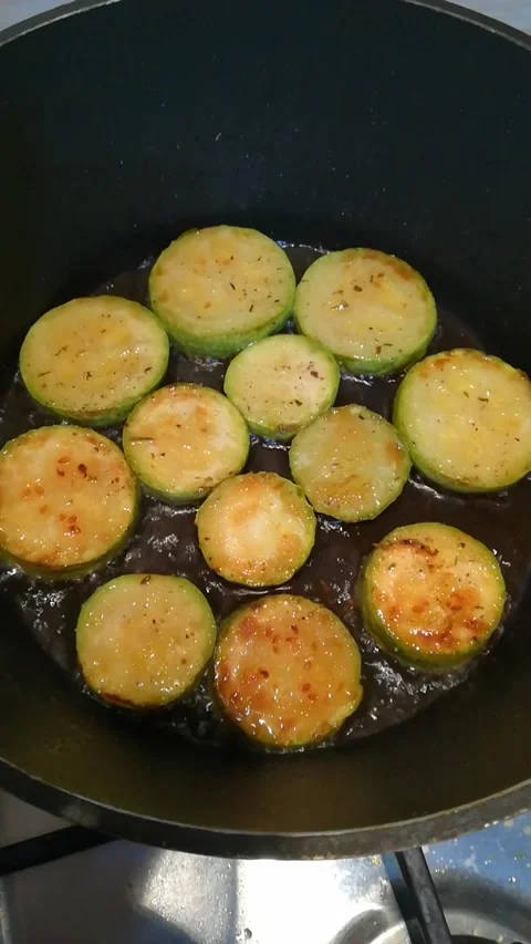 A lightly roasted zucchini is fried in sunflower oil in a frying pan Stock-Footage 201581258