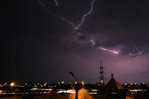 Lightning against the background of the sky with clouds Stock Photos