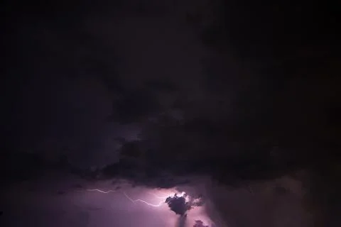 Lightning and rain clouds at night Stock Photos