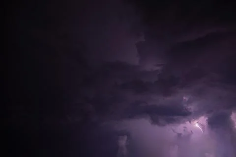 Lightning and rain clouds at night Stock Photos