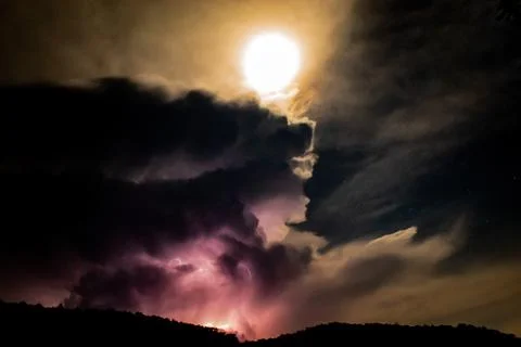Lightning Behind the Mountain at night Stock Photos