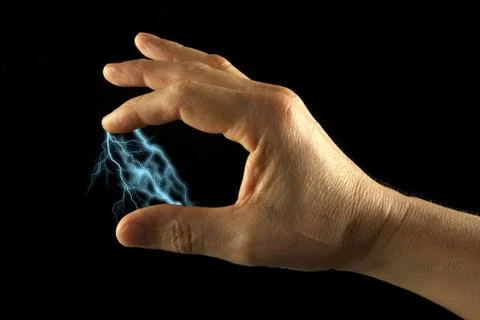 Lightning between two fingers. black background. Stock Photos