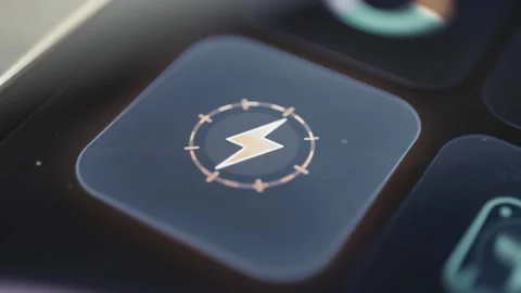 Lightning bolt inside a circular energy control on a dark touchscreen dashboard Stock Footage 342489233