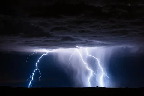 Lightning bolt strikes in a thunderstorm Stock Photos
