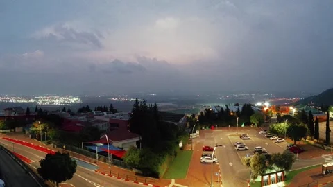 Lightning bolts and thunder above urban area and parking lot day to night Stock Footage 290201840