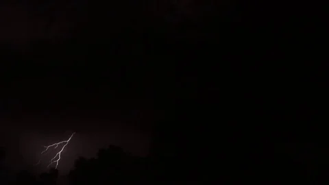 Lightning bolts and thunder before rain on dark black night sky Video stock 83563955