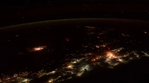 Lightning can be seen above a city at night in a clip of the Earth from space. Stock Footage 91161658