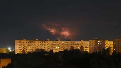 Lightning cloud at night, above Eastern Europe apartment buildings. Climate. Video stock 256988546