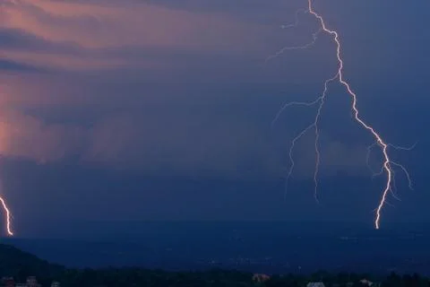 Lightning in the clouds on the horizon Stock Photos