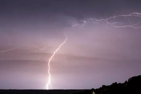 Lightning in the clouds on the horizon Stock Photos