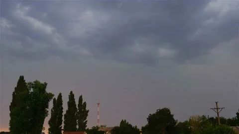 Lightning in the clouds in a thunderstorm. Evening city in rainy weather. Stock Footage 165509878