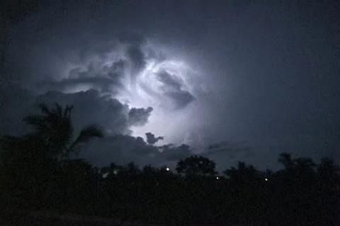 Lightning crawls across the night sky Stock Footage 12691923
