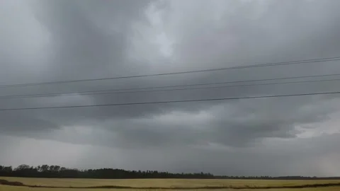 Lightning in the distance in the county try on a stormy dark cloud day Stock Footage 176075123