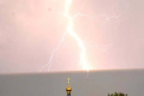 Lightning during a thunderstorm in the sky above the dome and cr Stock Photos