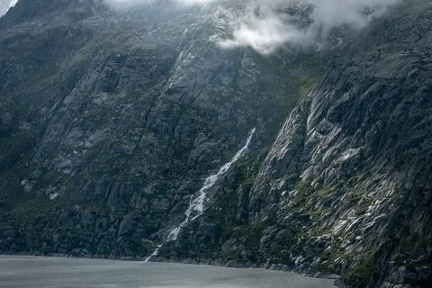 Lightning effect through the coulds in the mountains Stock Photos