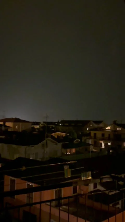 Lightning Flash Illuminates Night Sky Over Residential City During Thunderstorm. Stock Footage 338093250