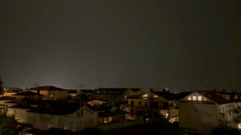 Lightning Flash Illuminates Night Sky Over Residential City During Thunderstorm. Stock Footage 338093439