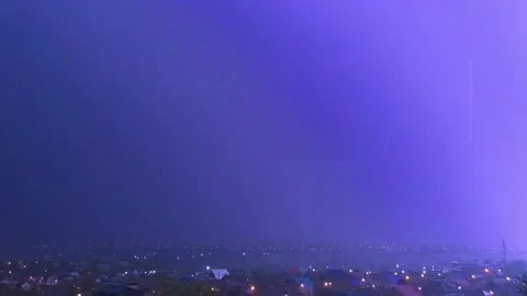 Lightning flash illuminating night sky during thunderstorm, dramatic weather sce Stock Footage 334660373