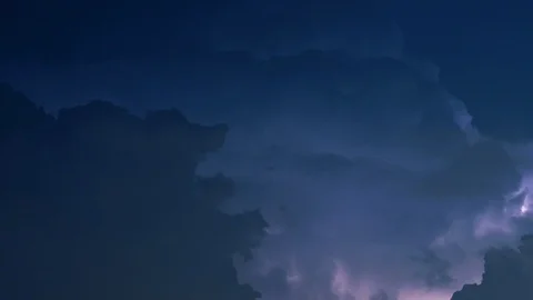 Lightning flashes in billowing night clouds TILT UP Stock Footage 108488352