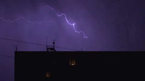 Lightning flashes in dark night sky during thunderstorm over city Stock Footage 238773324