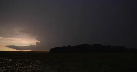 Lightning flashes on horizon under dark ominous sky Stock Footage 137459322
