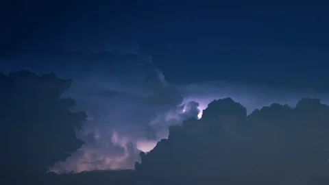Lightning flashes as stars fall into billowing clouds ZOOMING IN 4K Stock Footage 108487330