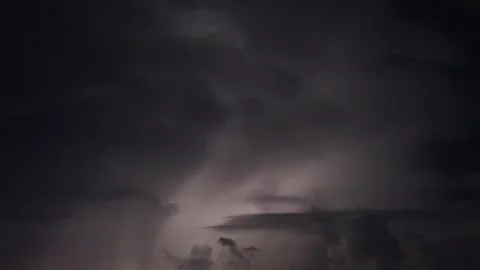 Lightning flashes through dark storm clouds. Black clouds before the thunde.. Stock Footage 282155219