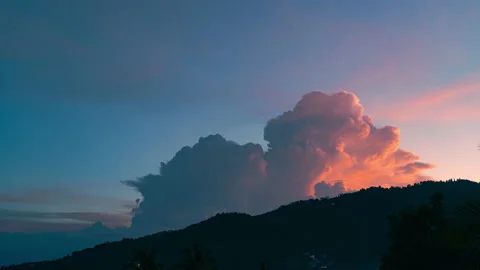 Lightning flashes through a large cloud over a mountain at sunset. 4K time lapse Stock Footage 205368966