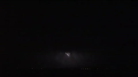 Lightning flashing in a darkened sky Stock Footage 501441