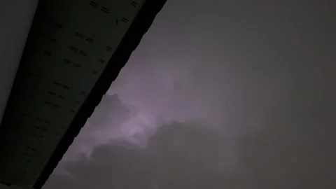 Lightning flashing through dark storm clouds at night. Stock Footage 345047981
