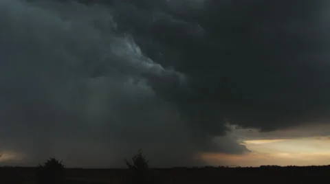 Lightning flickers and a curtain of rain or hail descends at the left  while a Stock-Footage 59261126