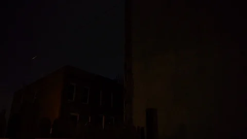Lightning Illuminates the City Sky Behind Buildings at Night Stock Footage 96046701
