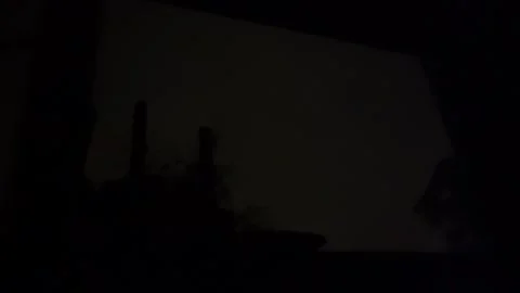 Lightning illuminates silhouetted bedroom window flashing atmospheric strike Stock-Footage 343876977