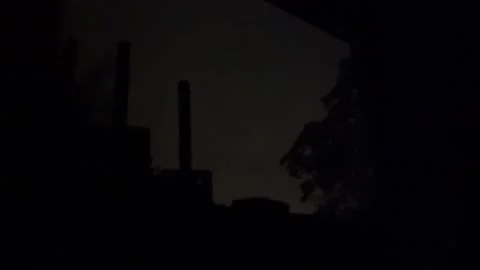 Lightning illuminates silhouetted bedroom window with atmospheric flash Stock Footage 343876990