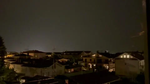 Lightning Illuminating Night Sky Above Urban Residential Area During Storm. Video stock 338093413