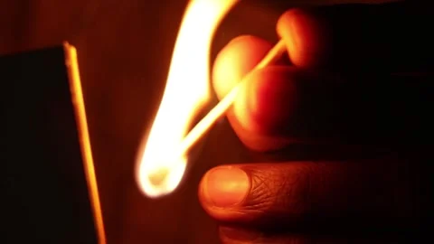 Lightning up matchstick in dark room close-up Stock Footage 255547284