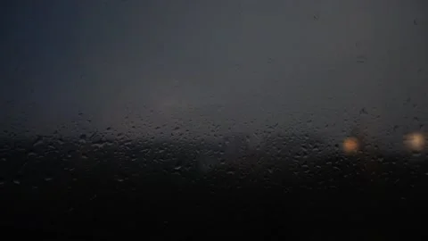 Lightning in the night sky through raindrops on the window. Stock Footage 209564479