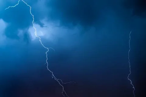 Lightning in the night sky. Thunderstorm over the city. Stormy clouds and r.. Fotos Stock