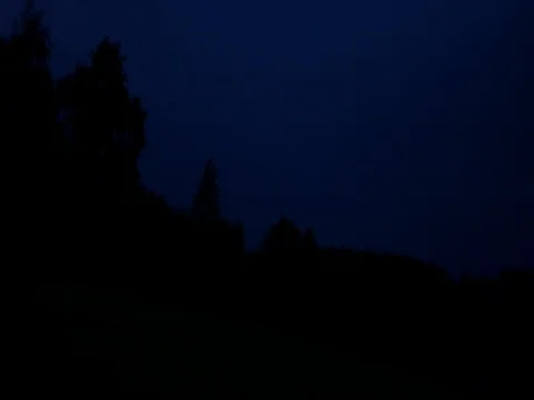 Lightning over a deciduous forest at nig... | Stock Video | Pond5