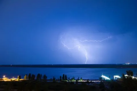 Lightning over the river Stock Photos