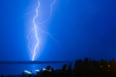 Lightning over the river Stock Photos